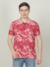 Man wearing a pink pink printed casual polo t shirt on a light gray background