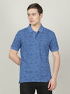 Man wearing a blue bright cobalt blue printed polo t shirt with casual styling on a gray background