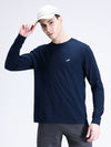 Man wearing a navy navy casual solid t shirt on a light gray background
