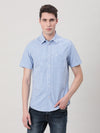 Man wearing a blue light blue checked half sleeve 100% cotton shirt on a light gray background