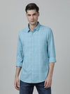 Man wearing a blue casual blue checked full sleeve 100% cotton shirt on a light gray background