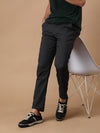 Man wearing a grey dark grey solid slim fit casual trouser on a light gray background