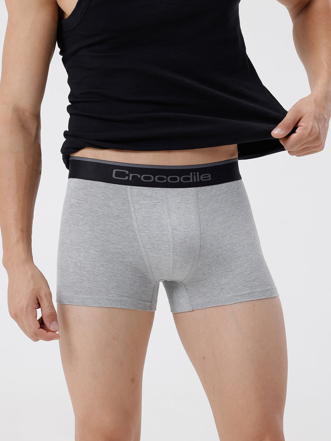 Person wearing gray boxer briefs with a black waistband featuring 'Crocodile' branding on a light gray background.