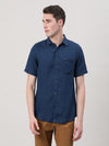 Man wearing a navy indigo navy solid half sleeve shirt on a light gray background