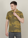 Man wearing a green light green printed casual polo t shirt on a light gray background