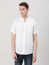 Man wearing a white off white solid half sleeve shirt with casual styling on a gray background