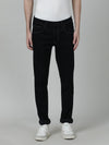Man wearing a red dark navy solid mid rise slim tapered jean on a light gray background