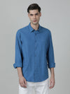 Man wearing a blue royal blue solid full sleeve linen shirt on a light gray background