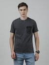 Man wearing a black solid casual t shirt black on a light gray background