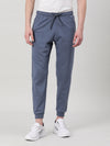 Man wearing a blue lightweight joggers in blue on a light gray background