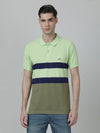 Man wearing a green striped olive green polo t shirt with casual styling on a gray background