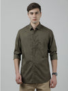 Man wearing a green olive green printed casual full sleeve 100% cotton shirt on a light gray background