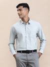 Man wearing a green elegant self-stripe stretch shirt green with casual styling on a gray background