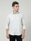 Man wearing a grey grey solid full sleeve 100% cotton shirt on a light gray background