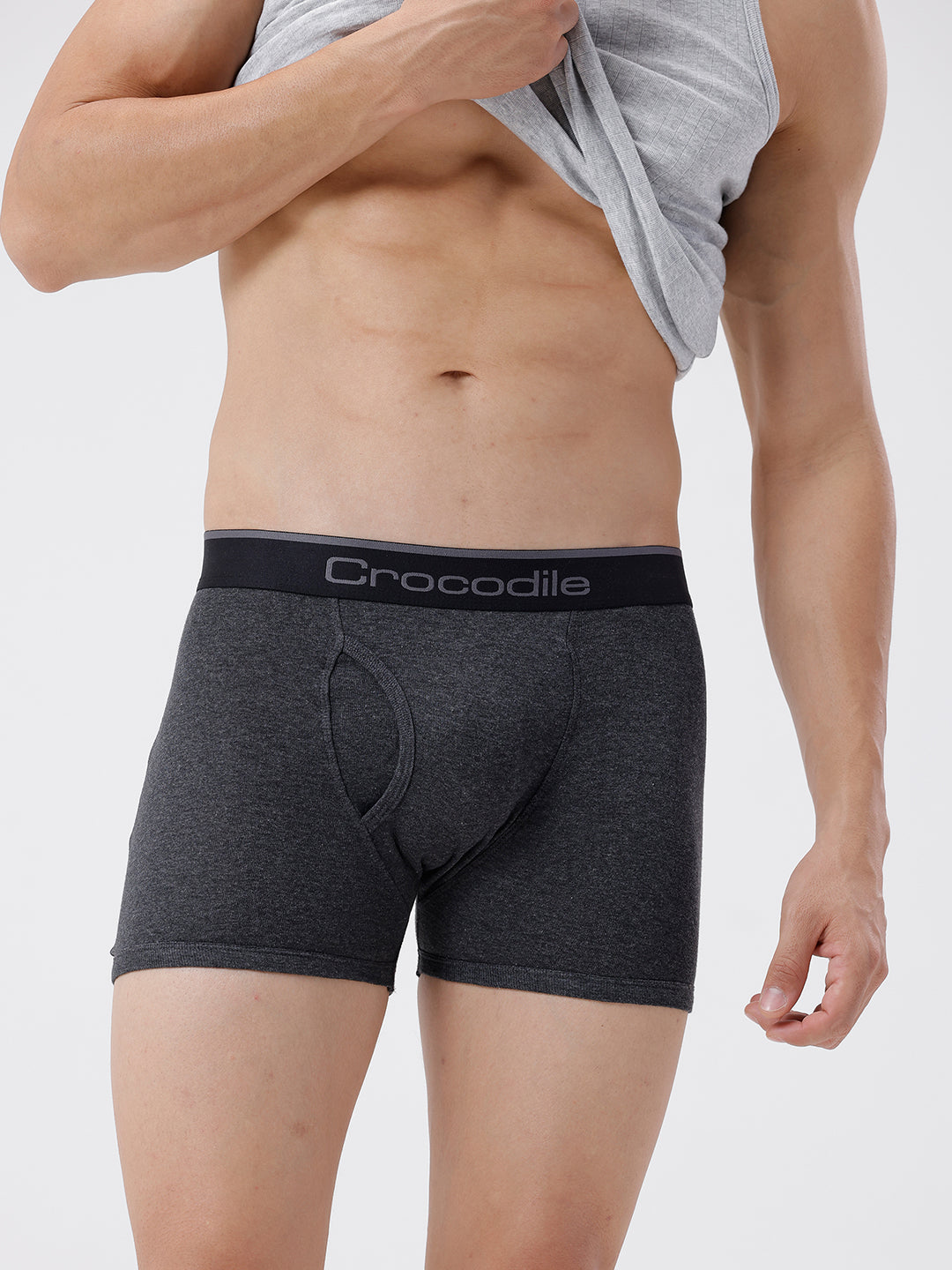 Person wearing gray men's underwear with 'Crocodile' brand logo on a light gray background