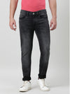 Man wearing a black black solid mid rise slim tapered jean with casual styling on a gray background