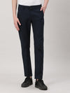 Man wearing a navy casual navy solid slim fit trouser with casual styling on a gray background