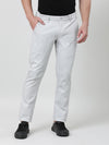 Man wearing a cream solid slim fit casual cream trouser with casual styling on a gray background