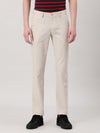 Man wearing a beige solid slim fit casual beige trouser with casual styling on a gray background