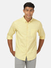 Man wearing a yellow lemon yellow solid full sleeve 100% cotton shirt on a light gray background
