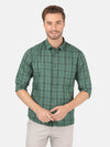 Man wearing a green checked full sleeve green shirt with casual styling on a gray background