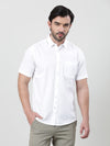 Man wearing a white white solid casual half sleeve 100% cotton shirt on a light gray background