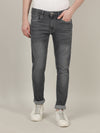 Man wearing a grey grey solid mid rise slim tapered casual jean on a light gray background