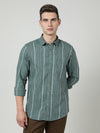Man wearing a green green striped full sleeve shirt with casual styling on a gray background