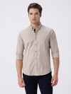 Man wearing a brown smart series premium oxford shirt brown with casual styling on a gray background