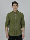 Man wearing a green olive green checked full sleeve casual shirt on a light gray background