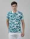 Man wearing a green green tie and dye polo t shirt with casual styling on a gray background