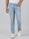 Man wearing a blue casual light blue solid mid rise slim fit jean on a light gray background