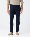 Man wearing a navy trouser navy slim fit solid with casual styling on a gray background