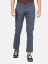 Man wearing a navy checked casual navy trouser on a light gray background
