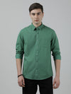 Man wearing a green green casual printed full sleeve 100% cotton shirt on a light gray background