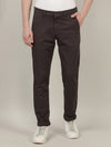 Man wearing a grey solid dark grey slim fit casual trouser with casual styling on a gray background