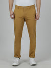 Man wearing a yellow yellow solid slim fit casual trouser on a light gray background