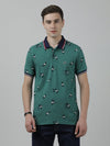 Man wearing a green printed casual polo t shirt green on a light gray background