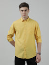 Man wearing a yellow yellow striped full sleeve linen casual shirt on a light gray background