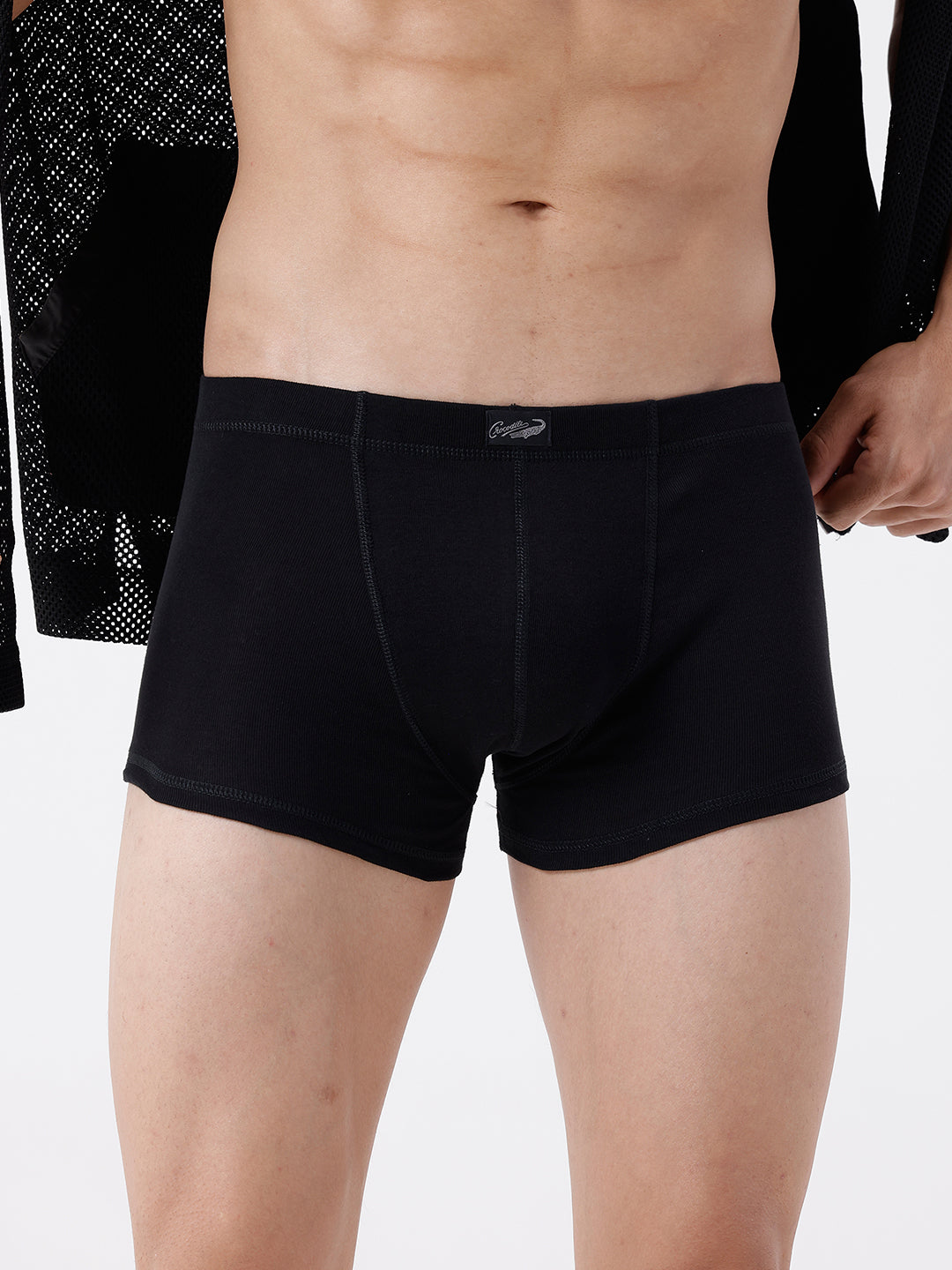 Person wearing black boxer briefs on a white background