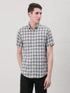 Man wearing a navy navy checked casual half sleeve 100% cotton shirt with casual styling on a gray background