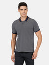 Man wearing a navy navy casual printed polo t shirt on a light gray background