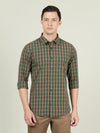 Man wearing a green green checked casual full sleeve 100% cotton shirt with casual styling on a gray background