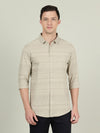 Man wearing a beige dark beige striped full sleeve shirt with casual styling on a gray background