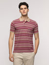 Man wearing a pink slim fit sport vintage pink t shirt for stylish wear on a light gray background
