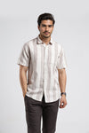 Man wearing a white variegated stripe textured chisel shape pocket comfort fit white shirts with casual styling on a gray background