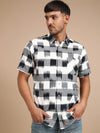 Man wearing a black checked black cotton half sleeve shirt with casual styling on a gray background