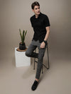 Man wearing a black black solid half sleeve 100% cotton casual shirt with casual styling on a gray background