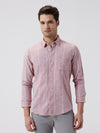 Man wearing a pink jacquard stripe shirt pink with casual styling on a gray background