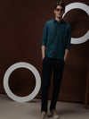 Man wearing a green teal green solid full sleeve 100% cotton shirt on a light gray background